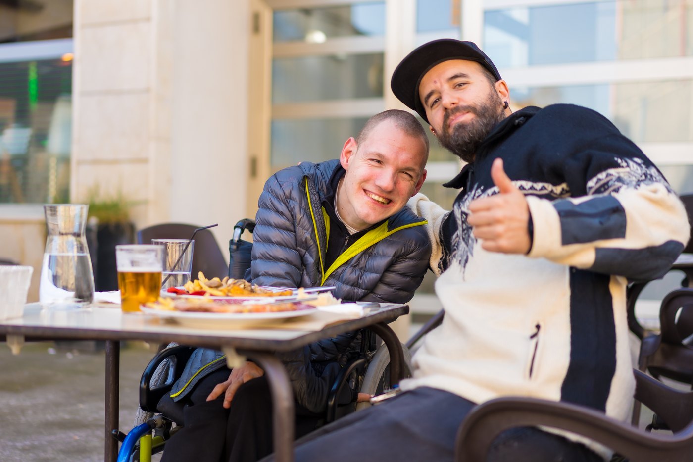 Two friends sharing a meal outdoors — companion care and community